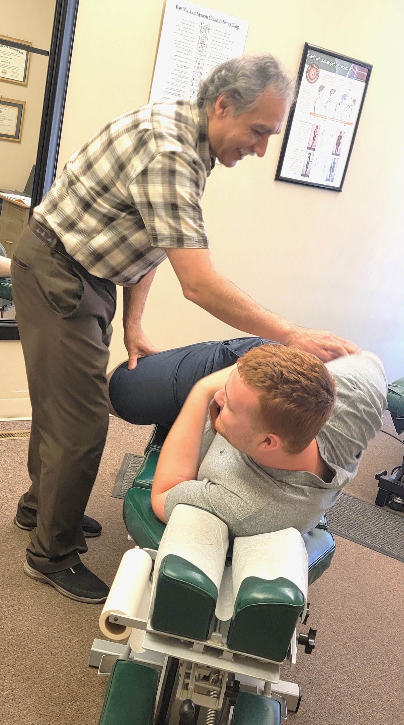 Dr. Ninan adjusts a patient in an office setting for treatment.